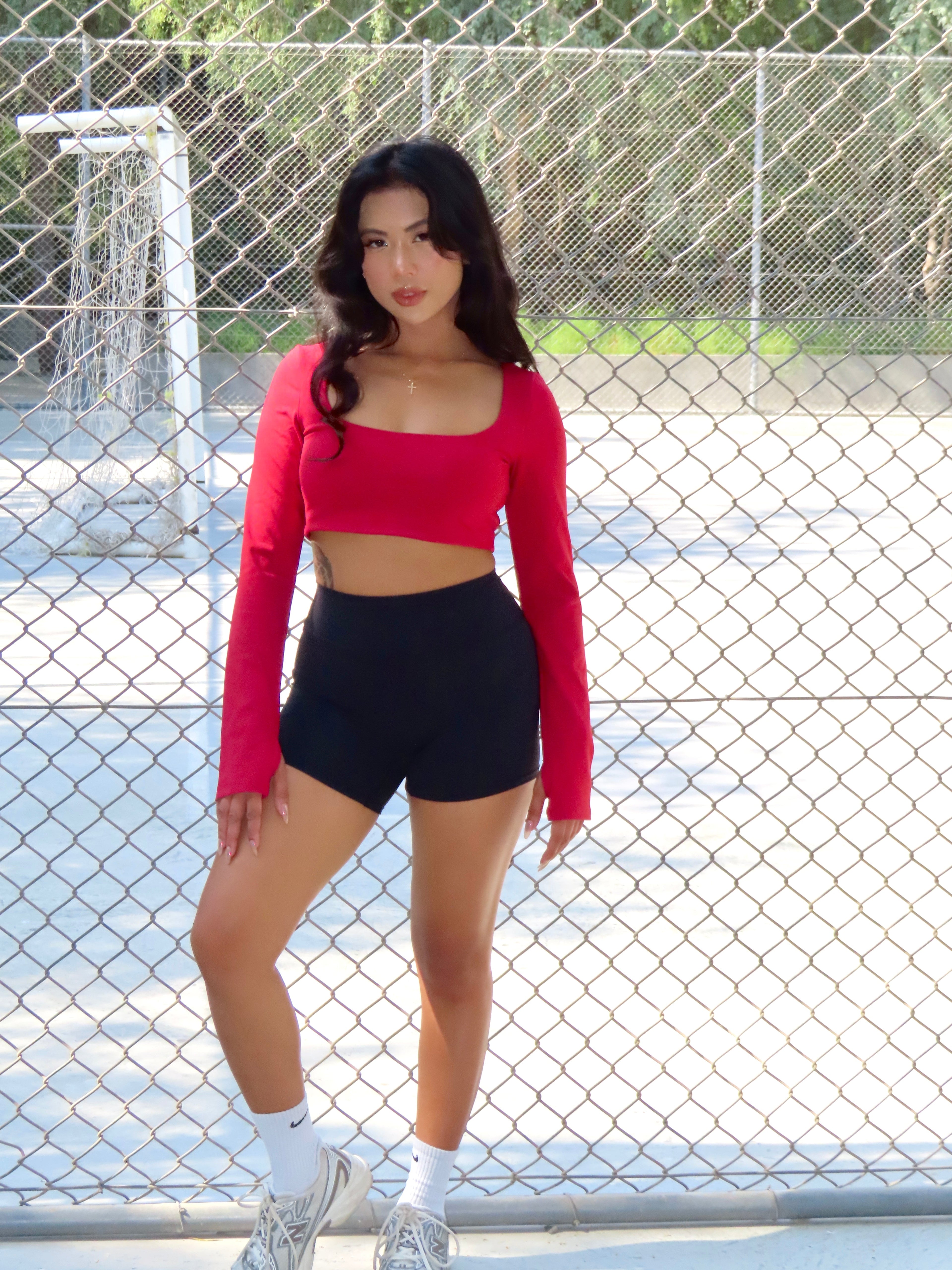 Woman in Fire Opal yoga top posing outdoors