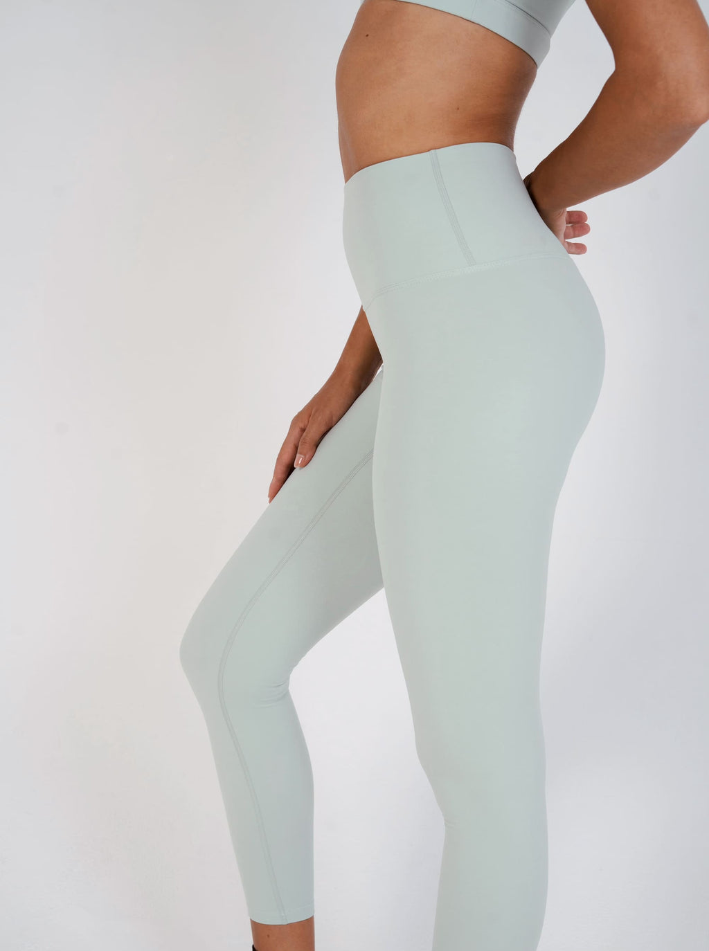 Light green leggings worn by a person on a white background