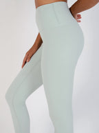 Light green leggings worn by a person on a white background