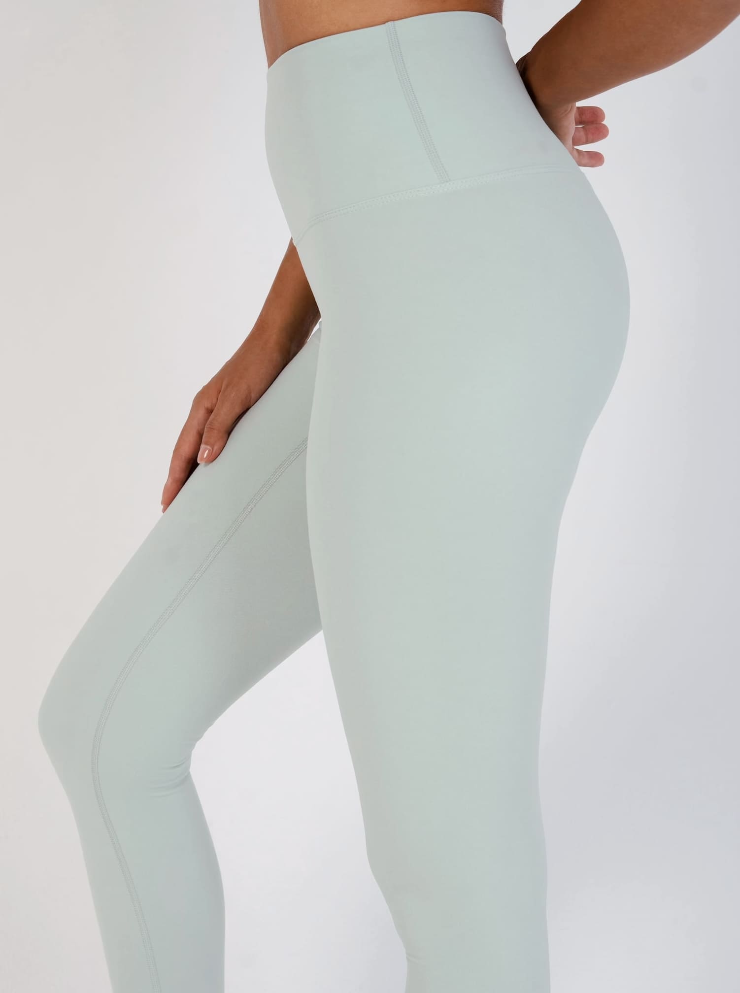 Light green leggings worn by a person on a white background