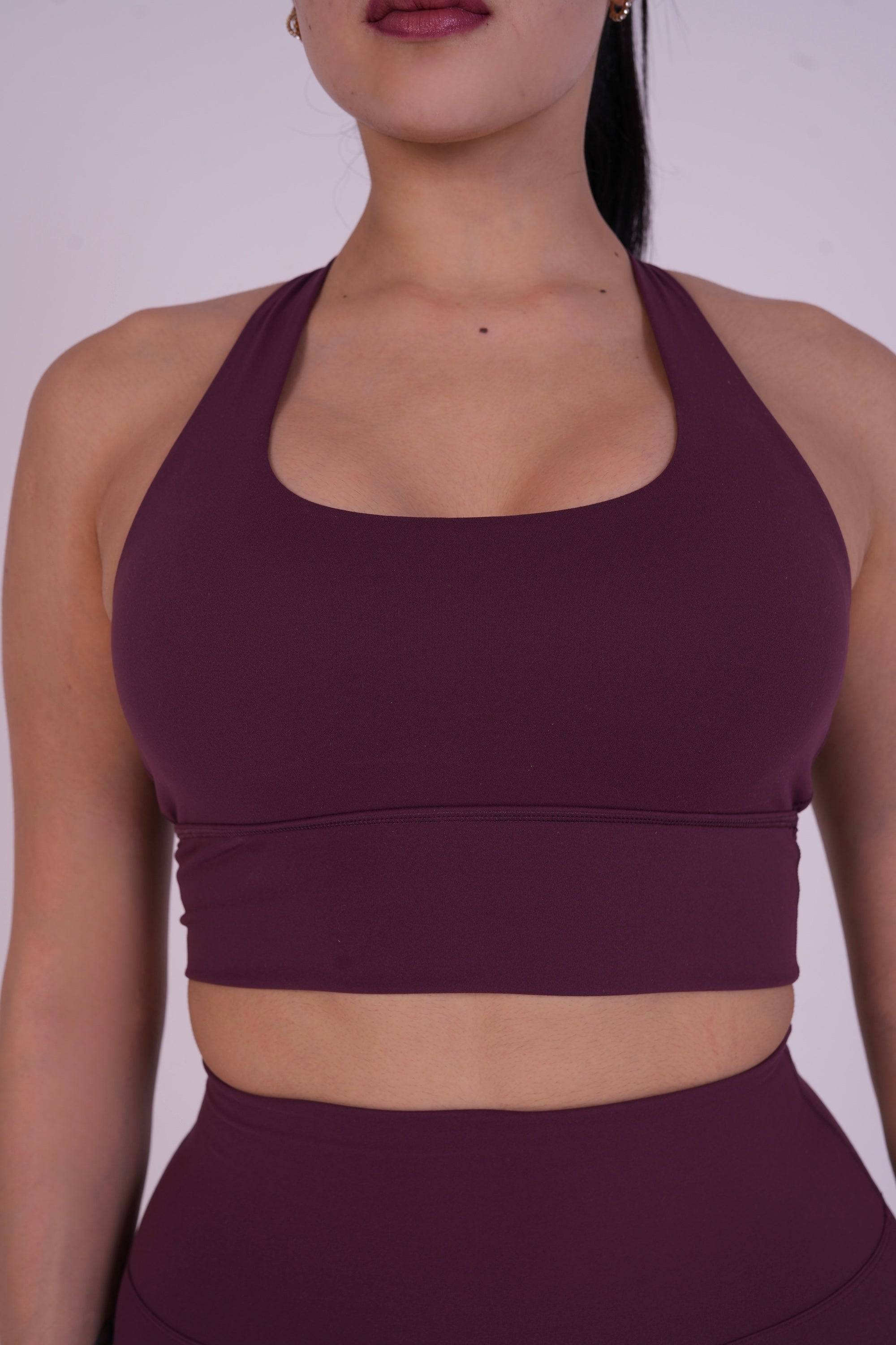 Close-up of NAVA Dark Garnet yoga bra showing supportive front design and buttery-soft fabric