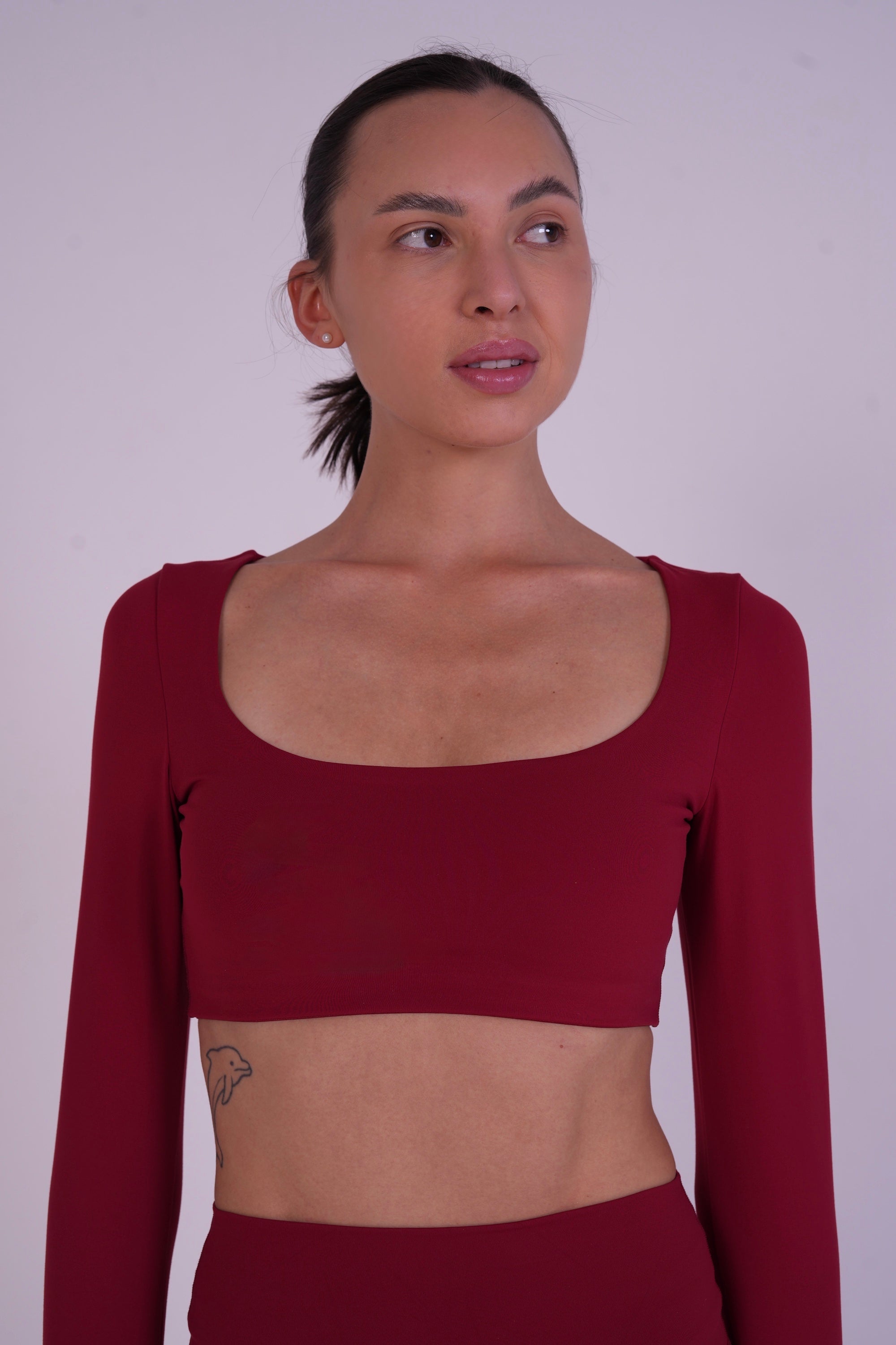 Front close-up of the NAVA Fire Opal bra top, showcasing the deep red gemstone tone and smooth, supportive fit.
