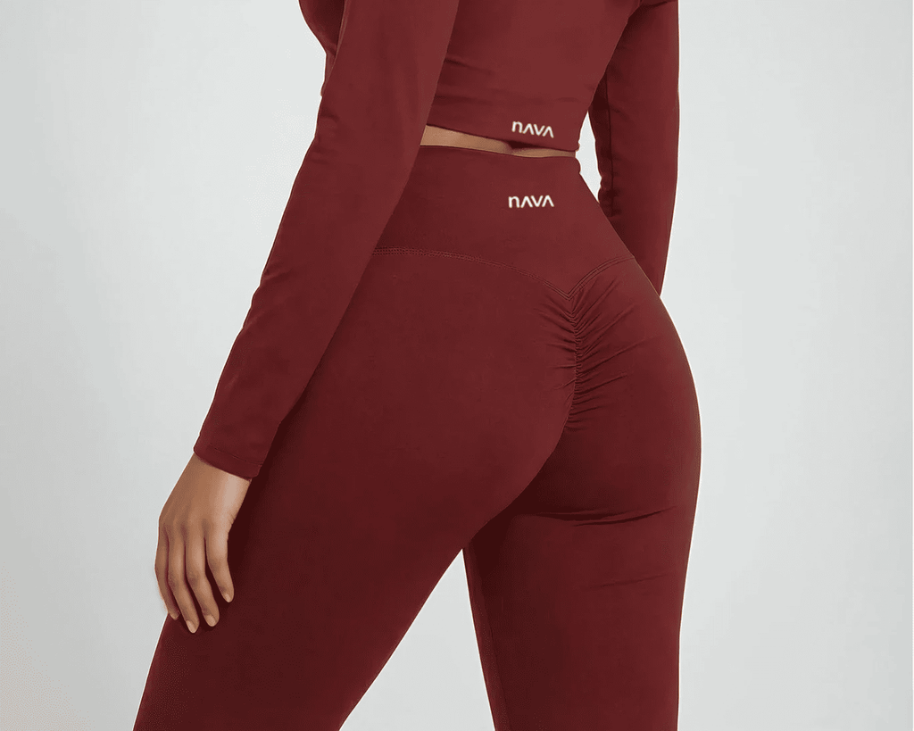 Maroon athletic outfit with 'NAVA' branding on a light gray background