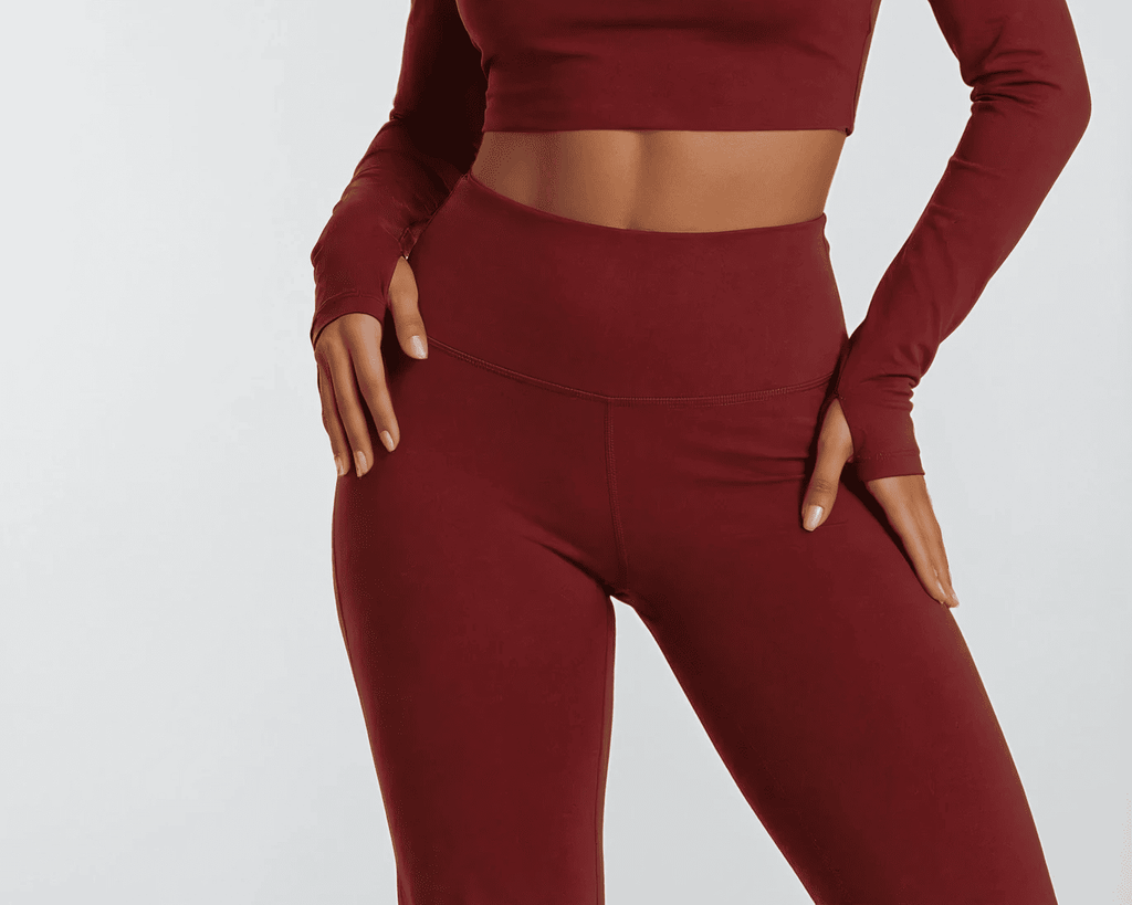 Maroon athletic outfit with long-sleeve top and leggings on a white background