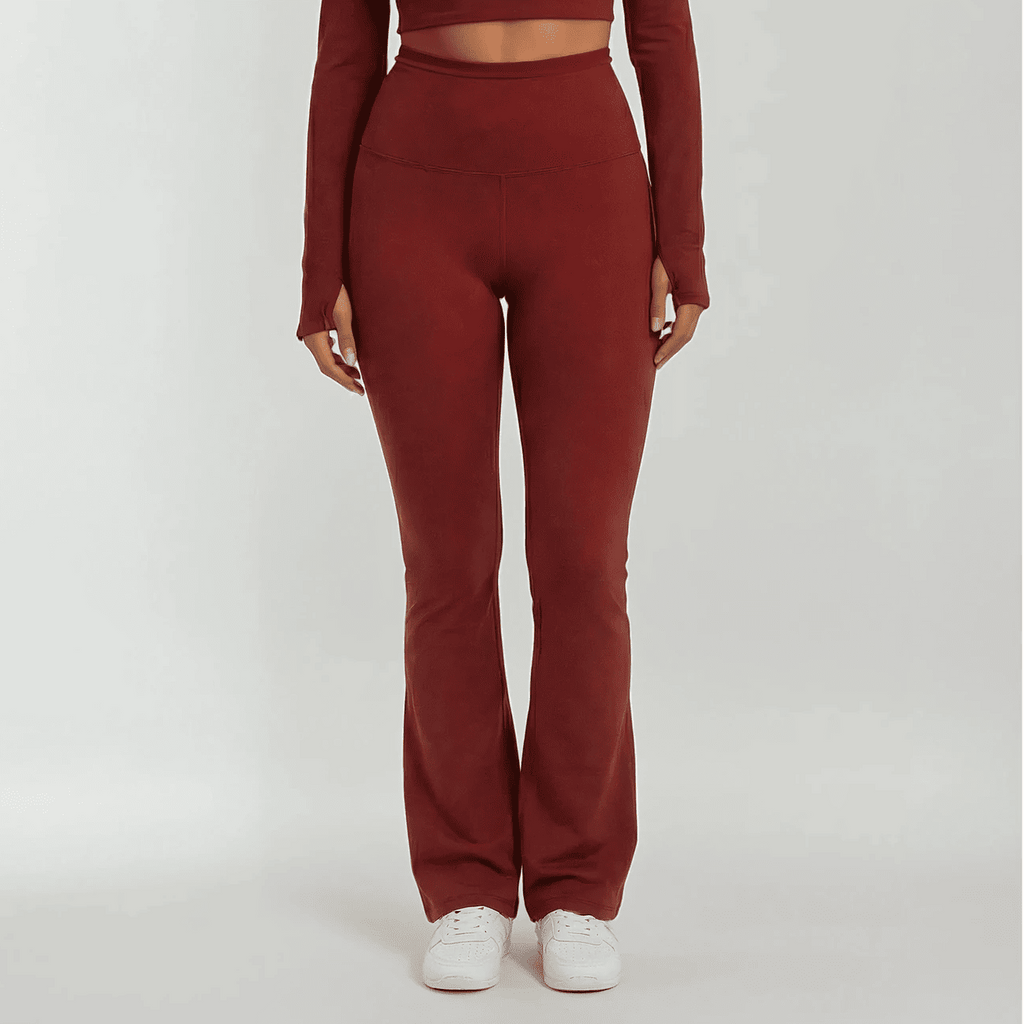 Maroon outfit with high-waisted pants and long-sleeve top on a white background
