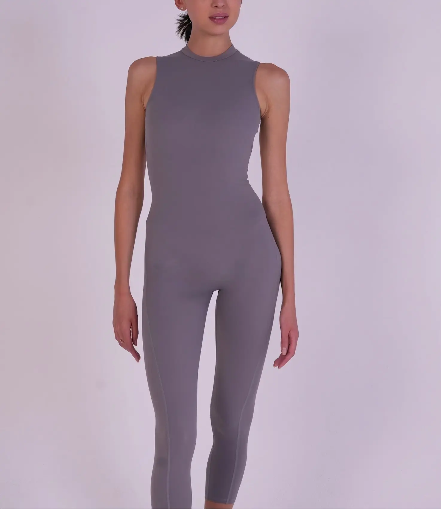 Front full-body view of the NAVA Grey Moonstone Jumpsuit, showcasing the soft grey gemstone tone and sleek contouring activewear fit.