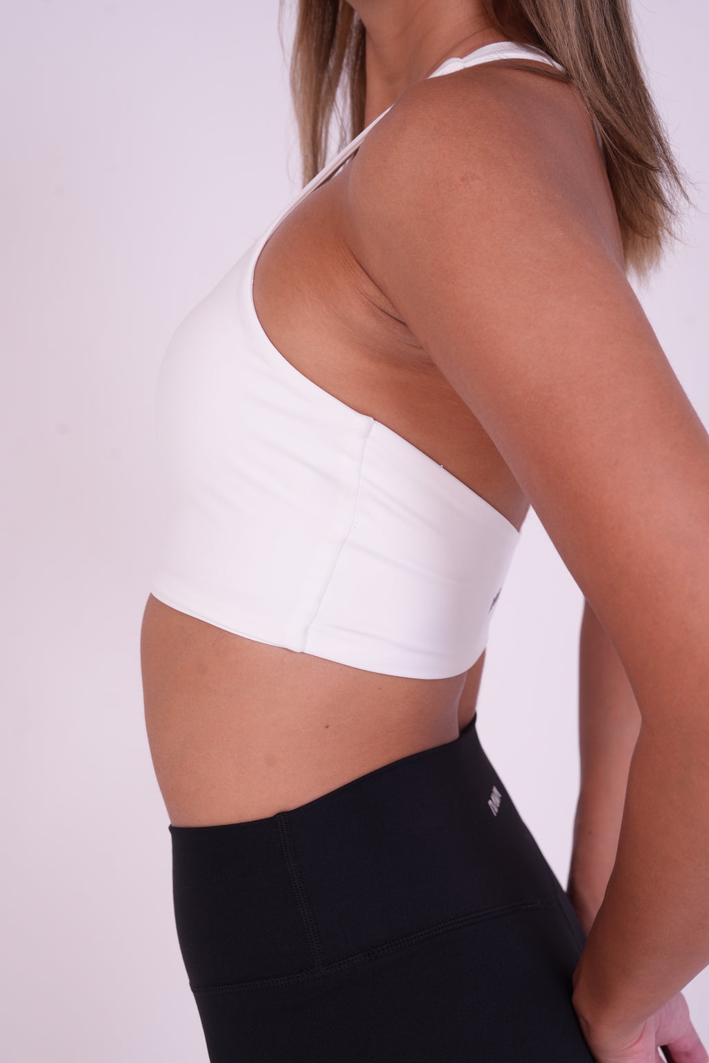 NAVA Milky Quartz white sports bra side view – high-neck activewear top for women