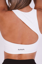 White sports bra with 'nava' branding on a plain background