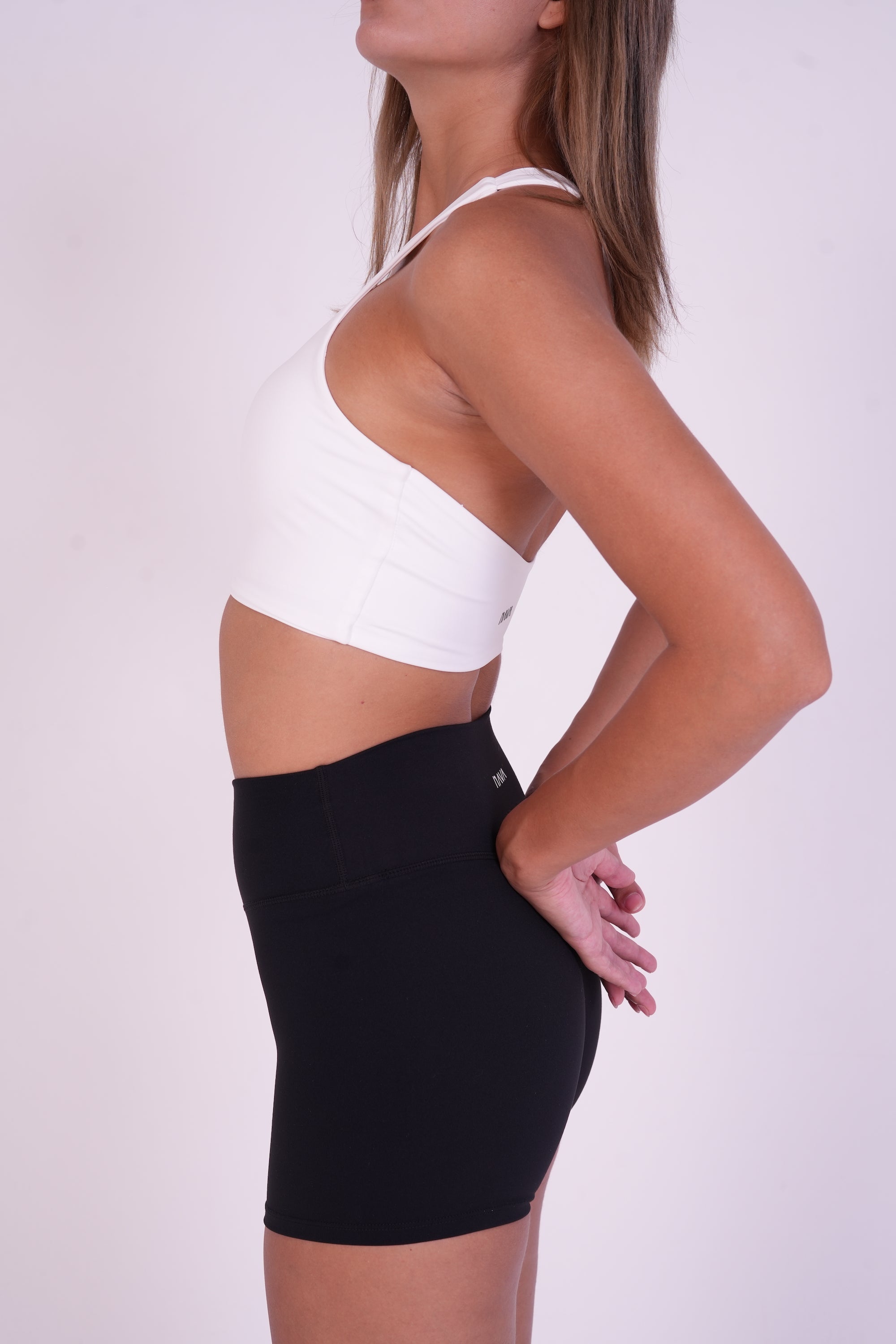 Side view of the NAVA Onyx Black shorts, showing the high-rise fit and smooth, sculpting activewear design UAE.
