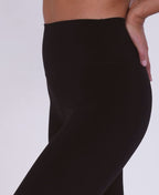 Black leggings worn by a person on a light gray background