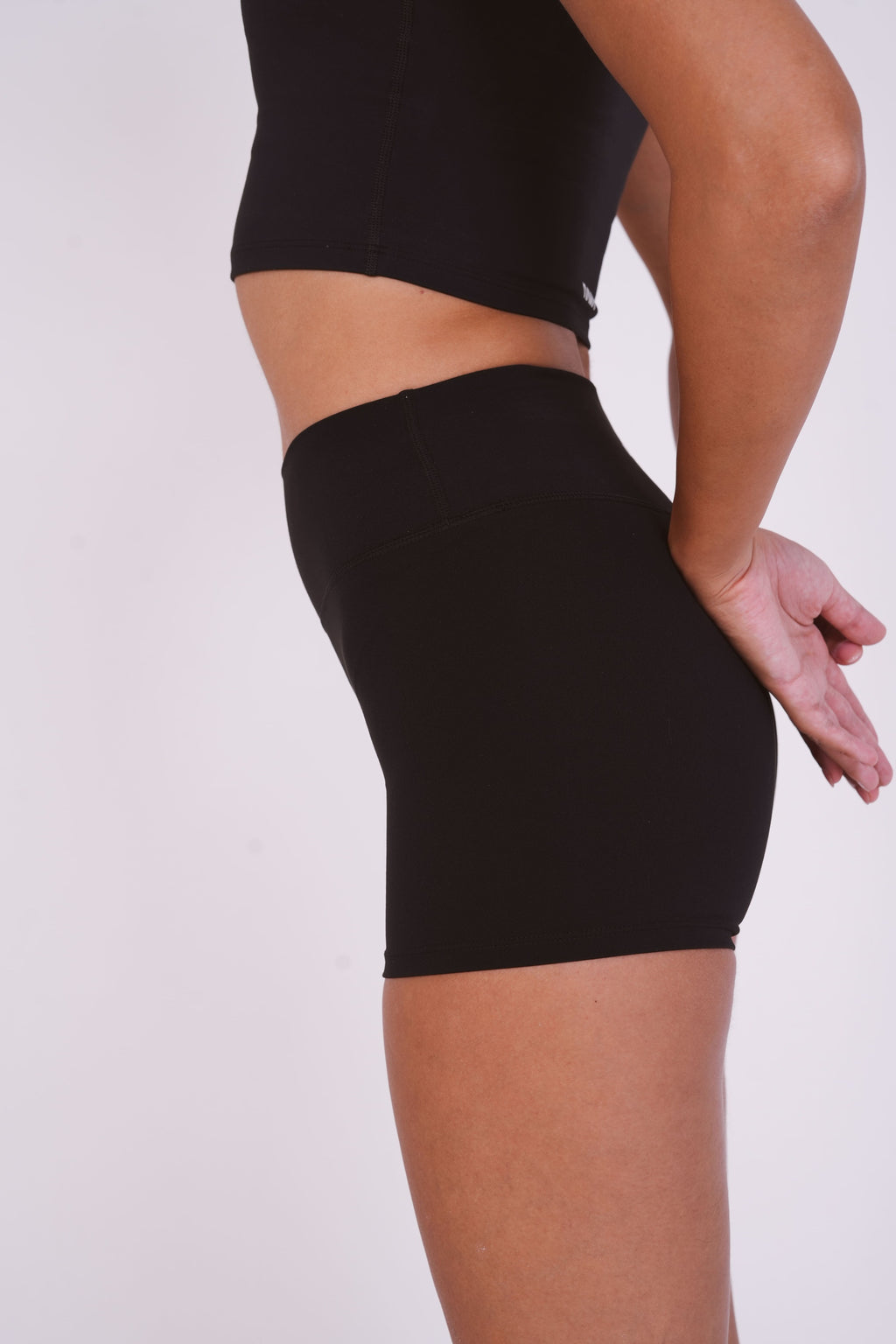Black compression shorts worn by a person on a white background
