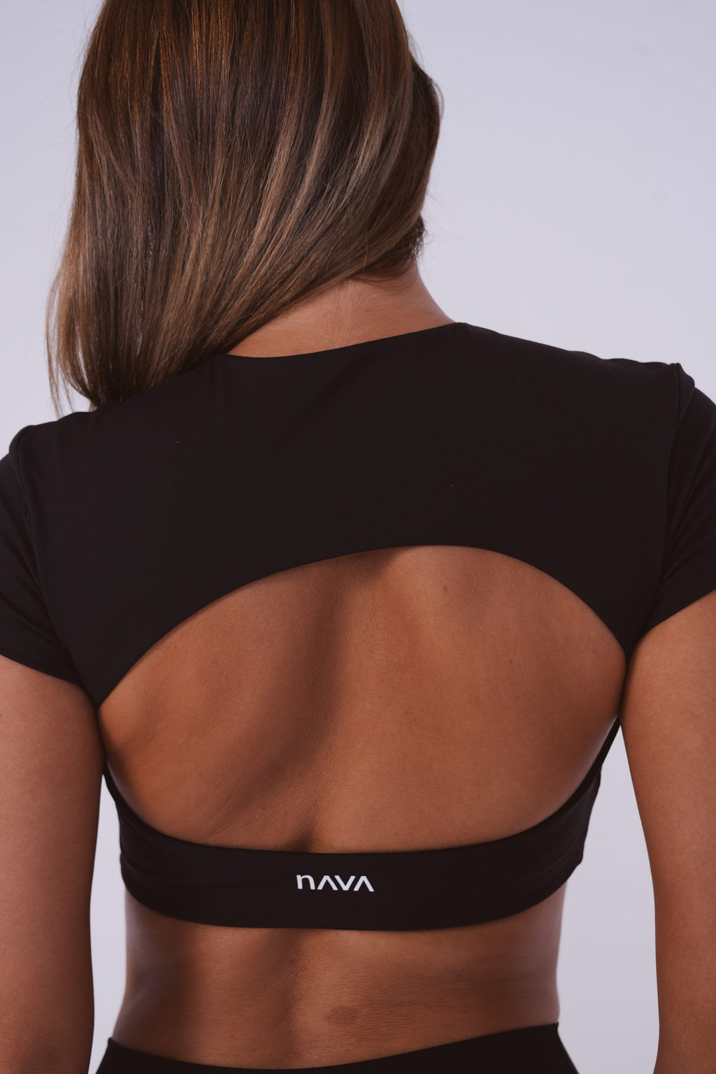 Black sports bra with 'Nava' brand logo on a plain background