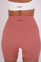 Pink leggings with 'Nava' branding on a white background