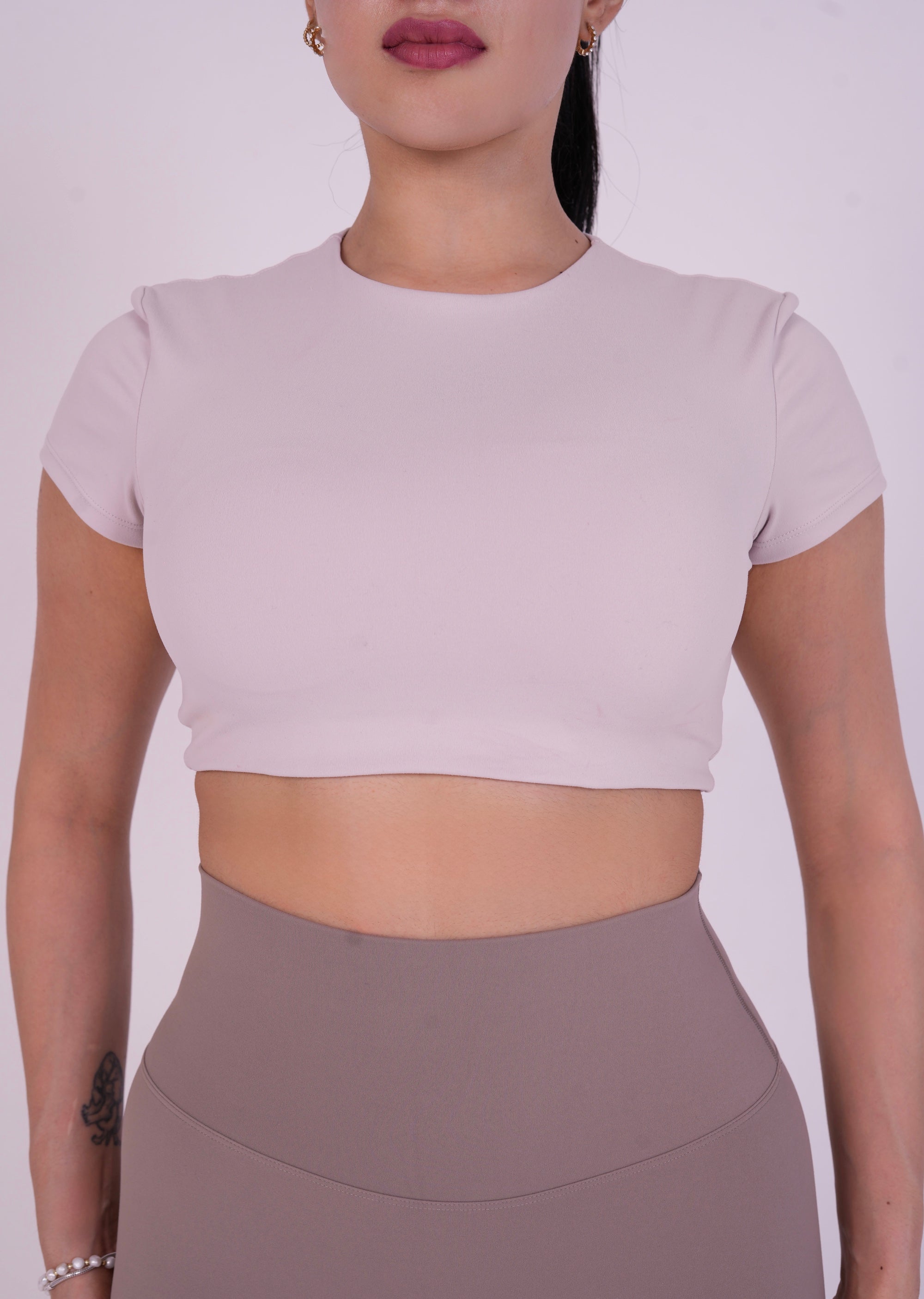 NAVA Smokey Quartz short sleeve crop top front close-up on model