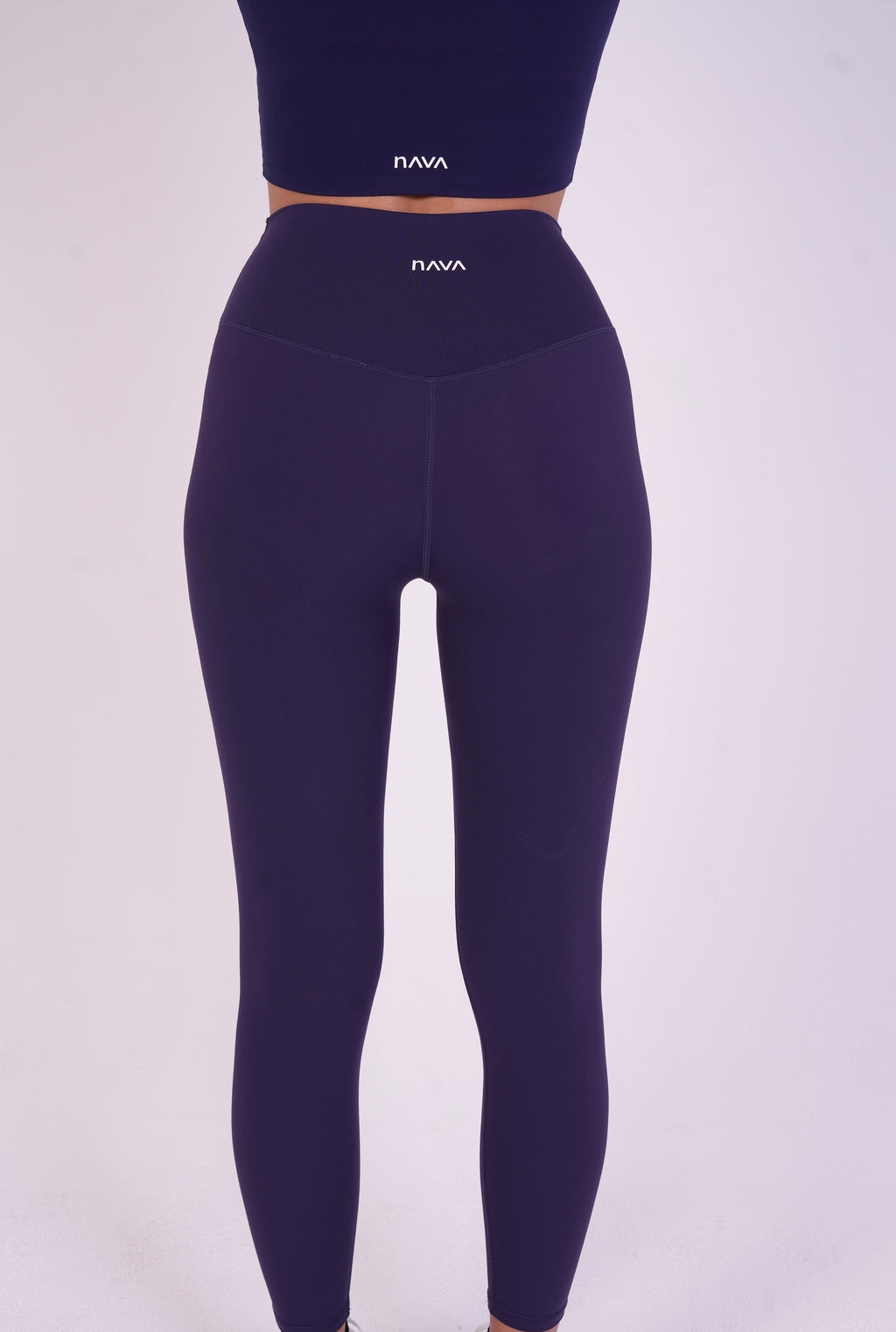 Model wearing NAVA Sodalite Blue Leggings – back view showcasing high-rise fit and seamless design.
