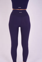 Model wearing NAVA Sodalite Blue Leggings – back view showcasing high-rise fit and seamless design.