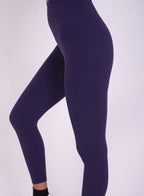 Model wearing NAVA Sodalite Blue Leggings in side view – high-rise, sculpting fit activewear.